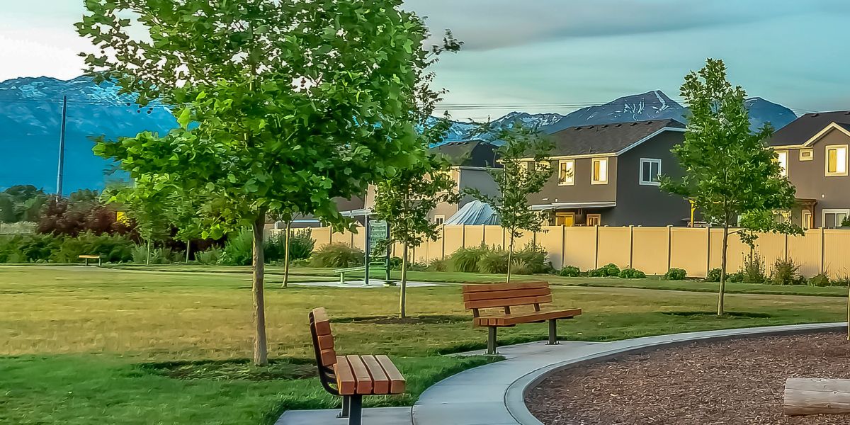 Park with benches, trees, and a view of suburban houses and mountains in the background.Park with benches, trees, and a view of suburban houses and mountains in the background.Park with benches, trees, and a view of suburban houses and mountains in the background.
