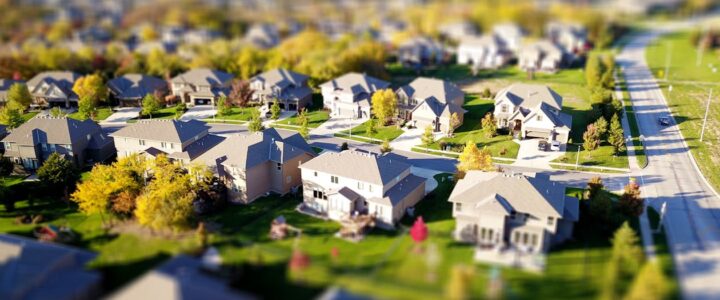 Insurance Industry Data: Uncovering Premium Discounts for New and Impact-Resistant Roofs Beautiful modern home with a new, dark-colored roof under a clear blue sky, illustrating the value of a quality roof for i...
