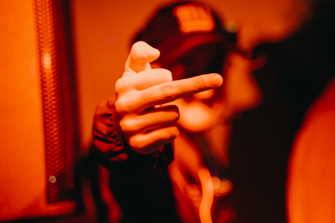 A close-up of a finger about to tap a glowing icon on a sleek, dark touchscreen, illustrating instant feedback and website responsiveness.
