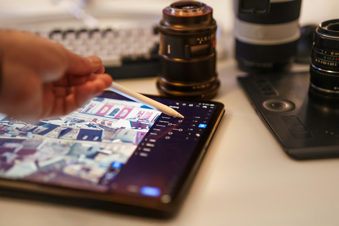 A close-up of a hand touching a clean, modern tablet screen in a bright, professional setting, symbolizing reducing digital friction for easy access to information.